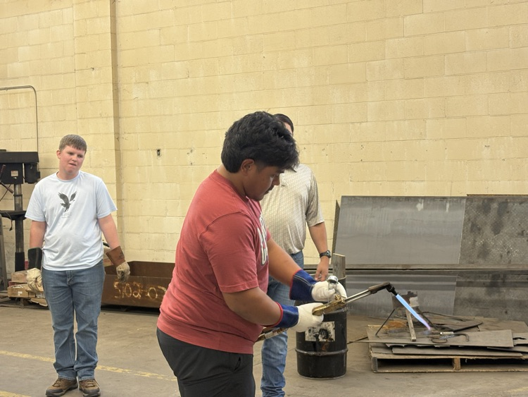 Students practicing lighting a torch in Welding II class