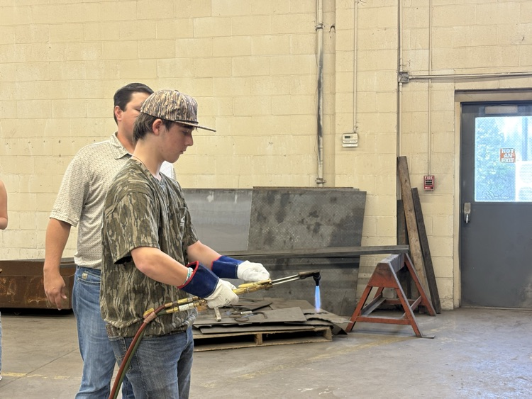 Students practicing lighting a torch in Welding II class