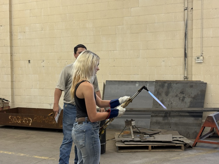 Students practicing lighting a torch in Welding II class