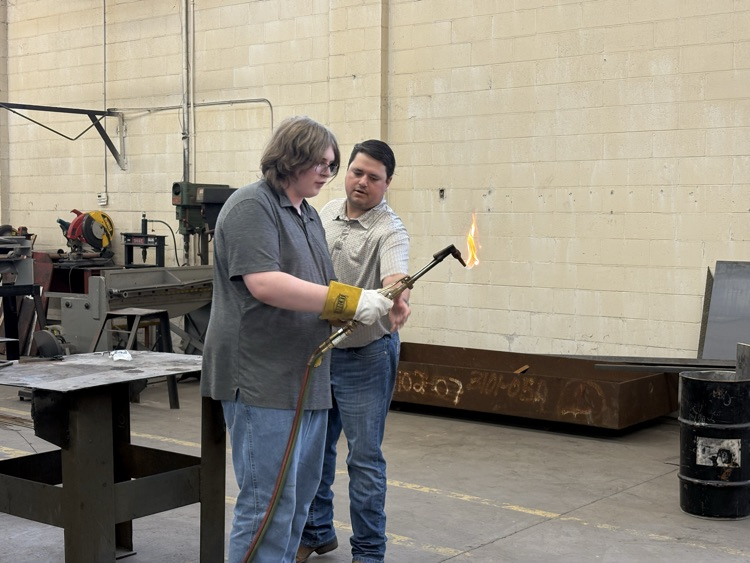 Students practicing lighting a torch in Welding II class