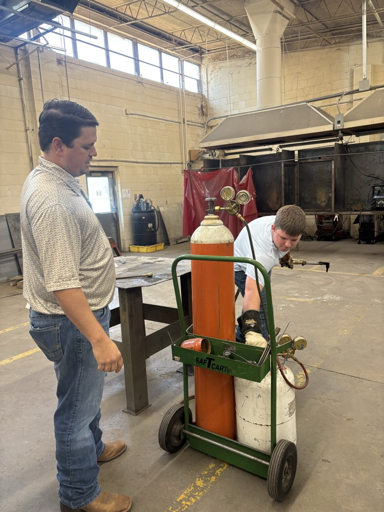 Students practicing lighting a torch in Welding II class