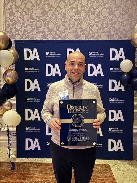 Mr. Ryan Ruggles accepting the District of Distinction awards plaque