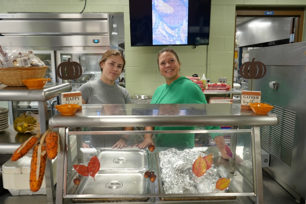 Ms. Cargian and Mrs. Fitzgerald smile on opening day for Bistro 555
