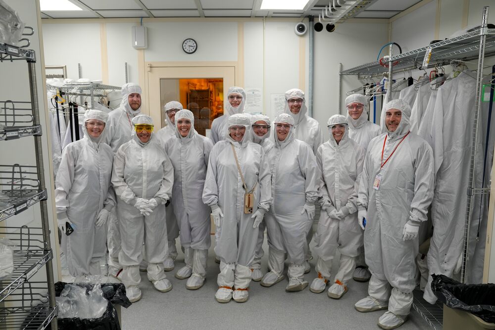 A group of TST BOCES, NYSED and Cornell representatives pose together in cleanroom suits inside the Cornell NanoScale Science and Technology Facility during Commissioner Betty A. Rosa’s visit to the New Visions Engineering program.