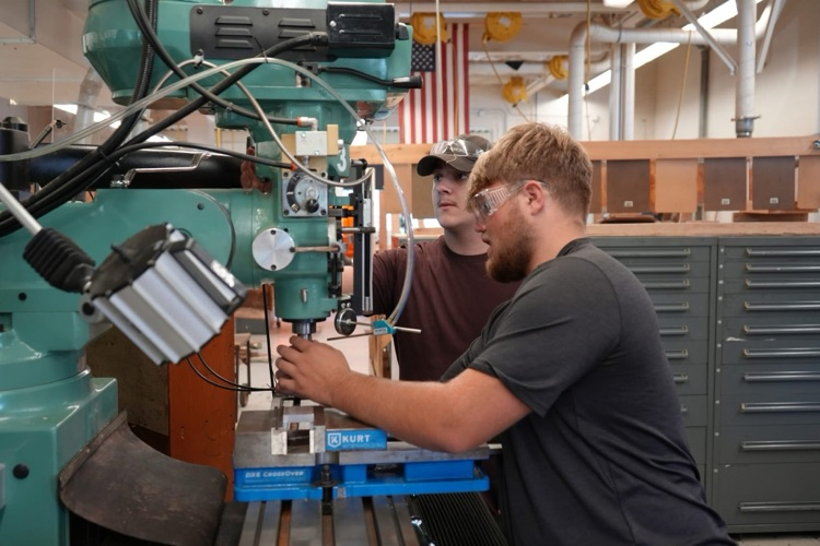 students working on a machine