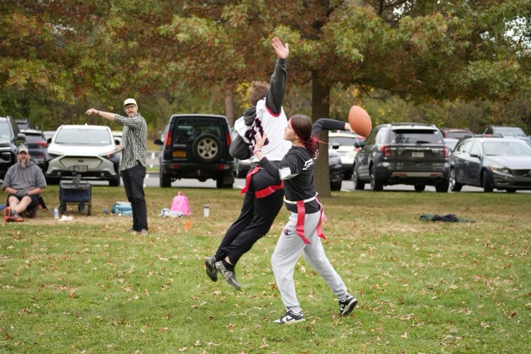 two football players; one throwing, one playing defense