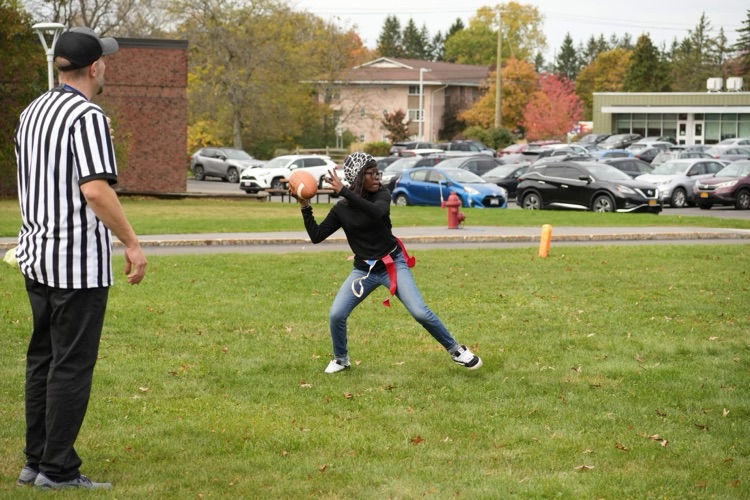 student throwing football