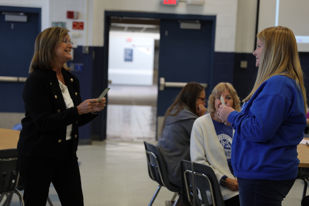 Faculty doing an interactive card game activity with another adult