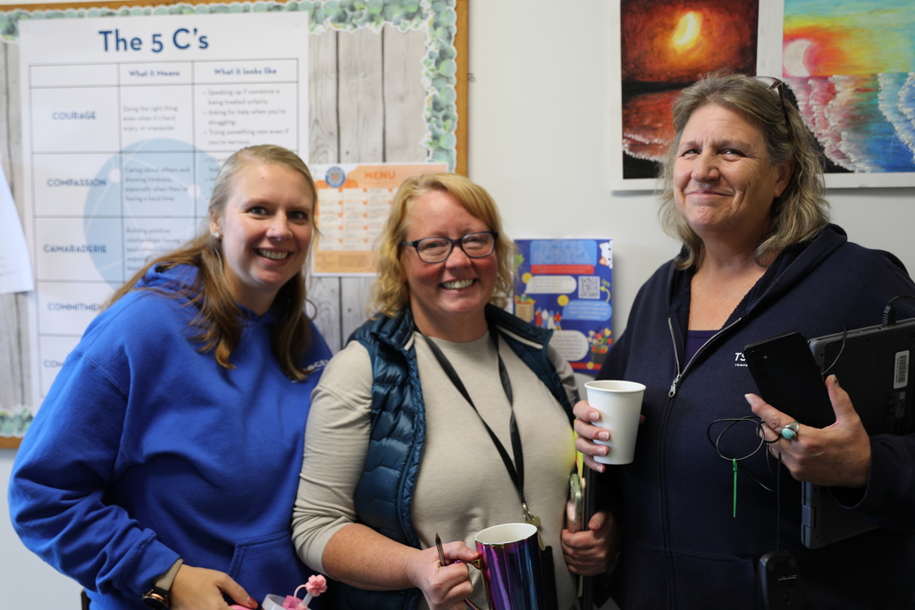 three adults smiling for a photo