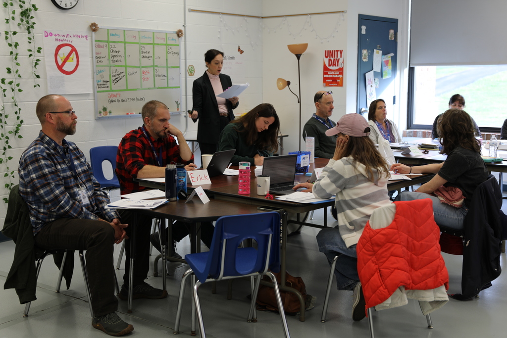 Faculty teaching in a room full of adults