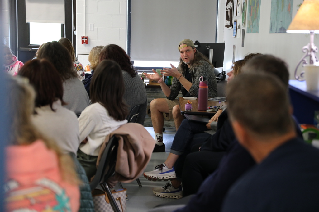 Faculty teaching in a full room of adults