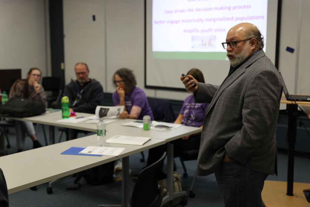 Faculty teaching a room full of adult 