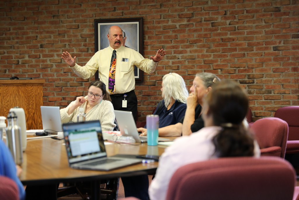 An administrator teaching a room full of adults