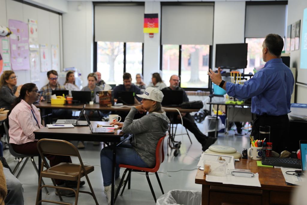 Faculty teaching in a room full of adults