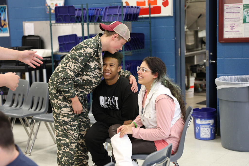 A student giving another student a hug