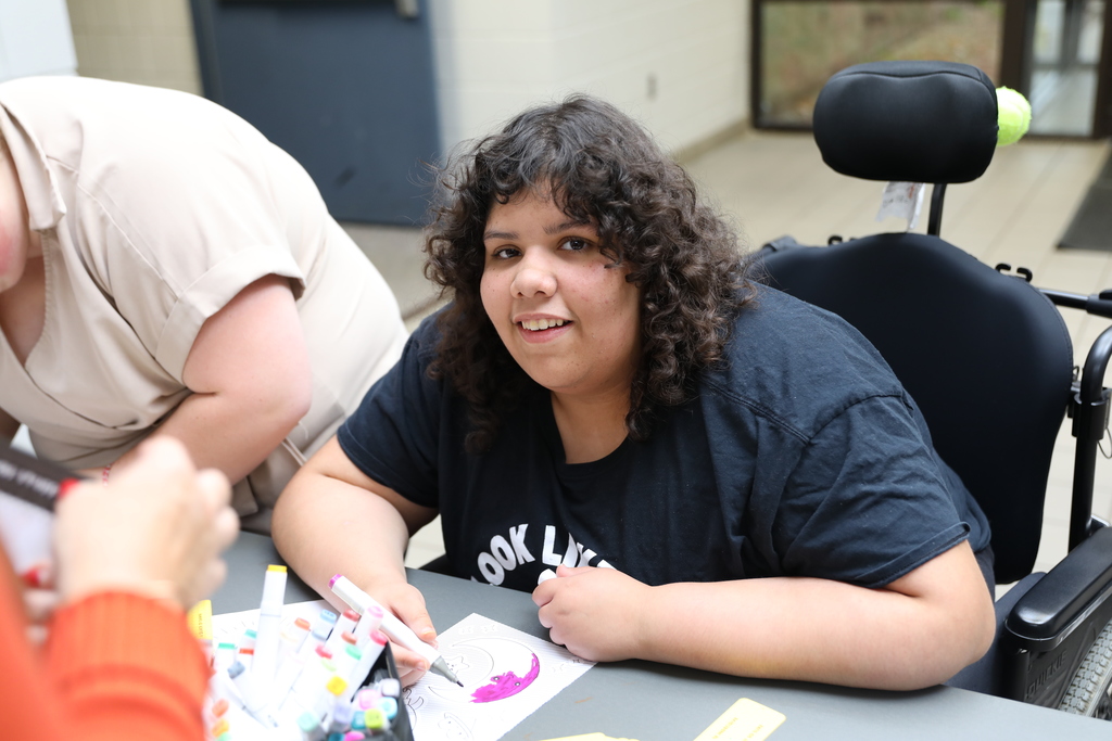 a student looking directly at the camera and smiling
