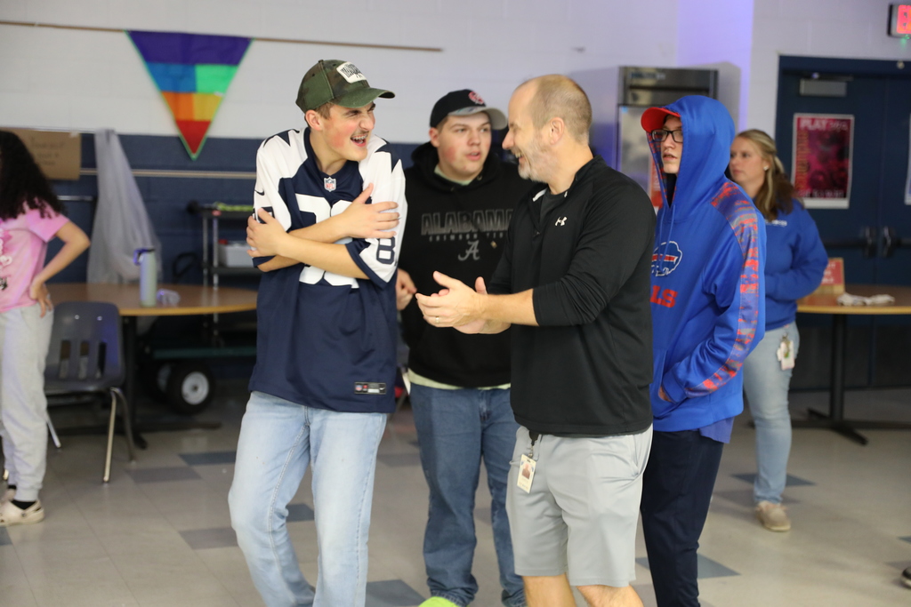 3 students and an adult dancing