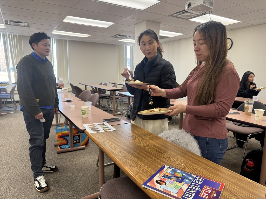 three adults eating some food 