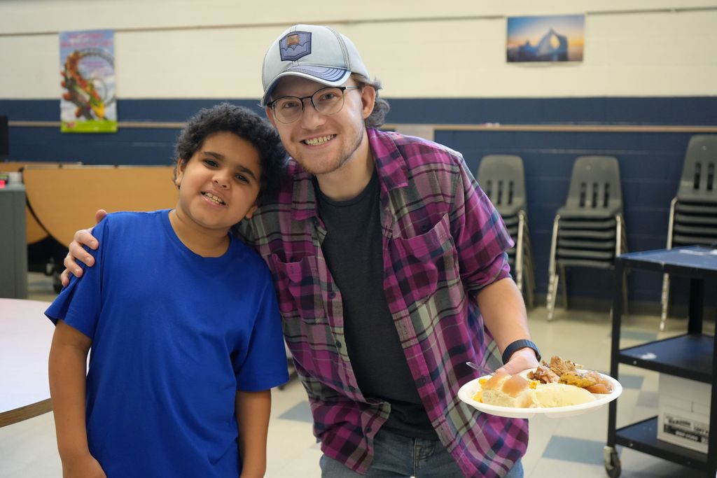 A student and adult posing for a photo