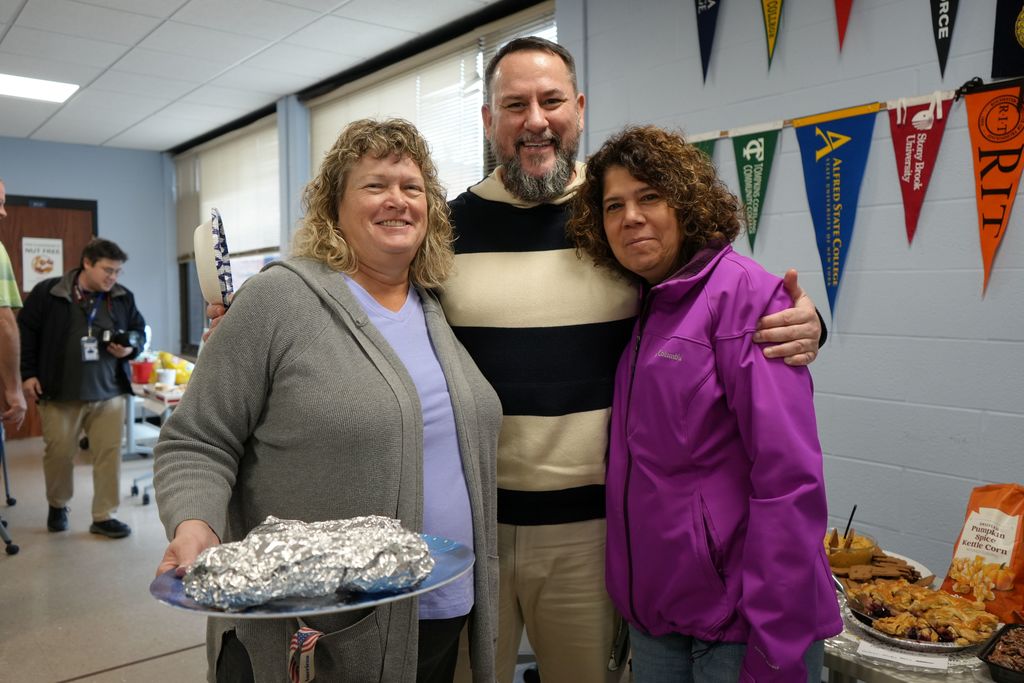 3 adults posing for a photo 