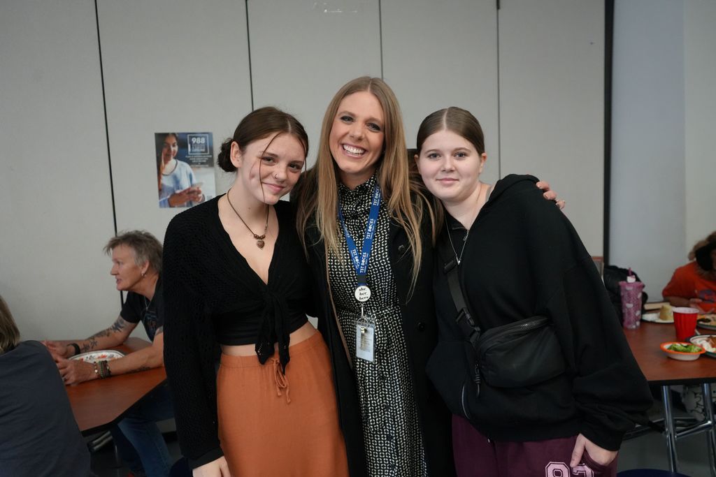 Two students posing with the Superintendent 
