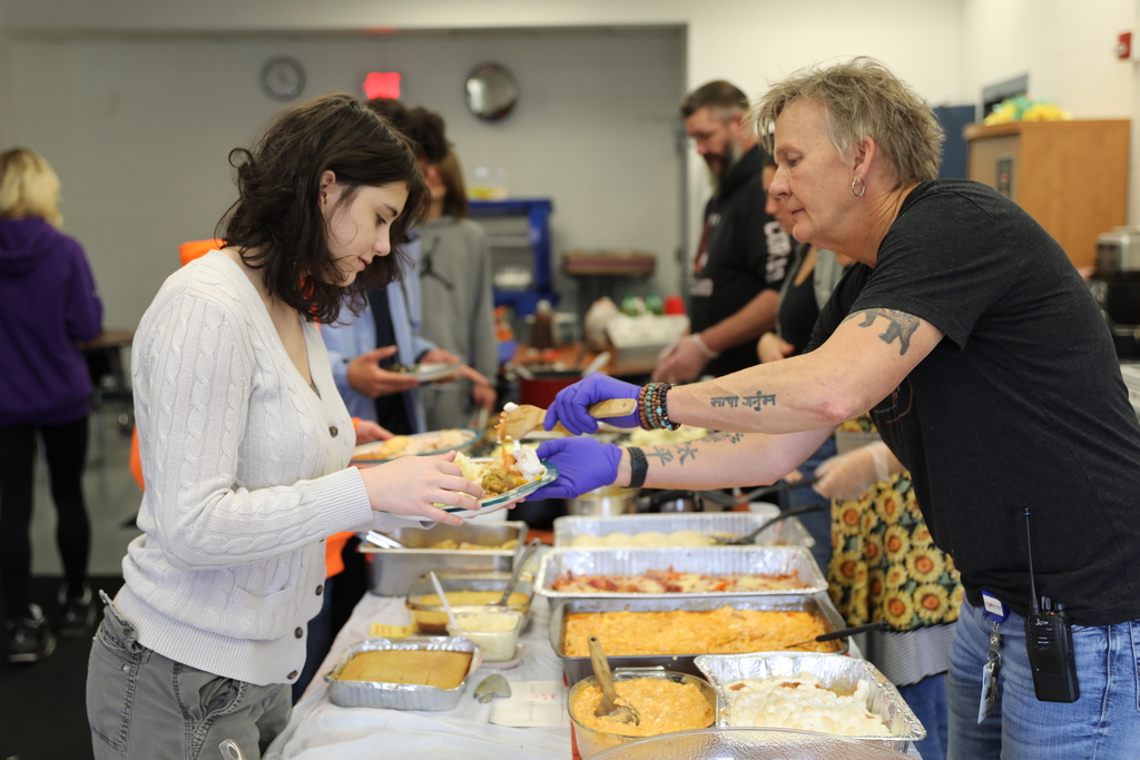 A student being served food by staff