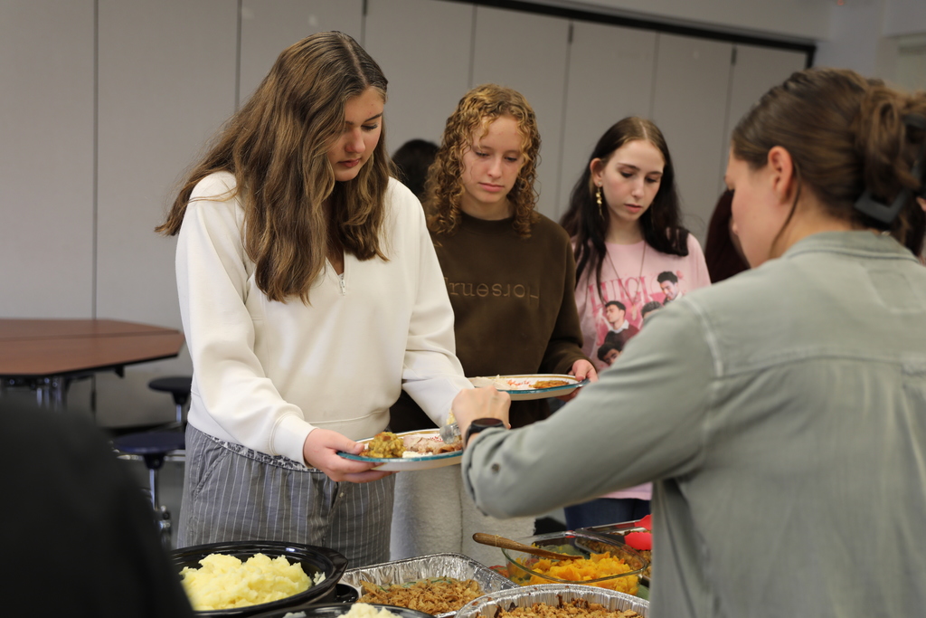 A student being served food by staff