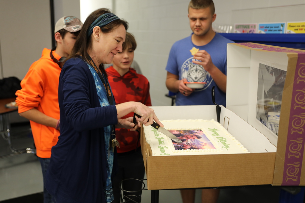 A cake being cut for dessert 