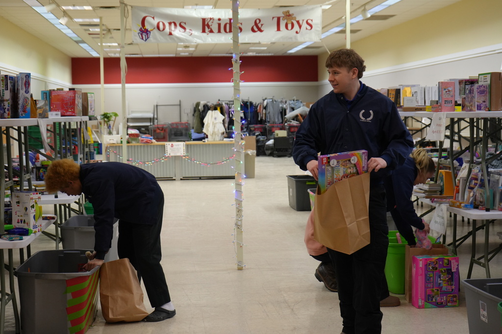 Some students filling bags with toys