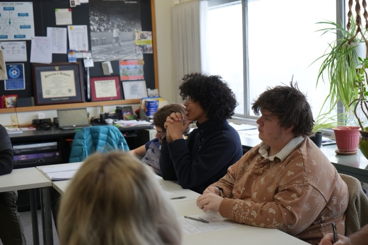 Anna Kelles visits ptech students to discuss HABs. this image shows an audience member asking a question to Dr. Kelles. 