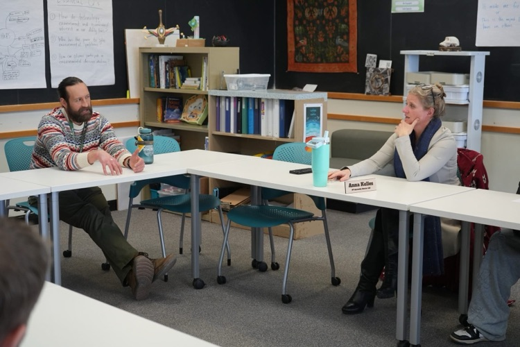 Anna Kelles visits ptech students to discuss HABs. this image shows an audience member asking a question to Dr. Kelles. 