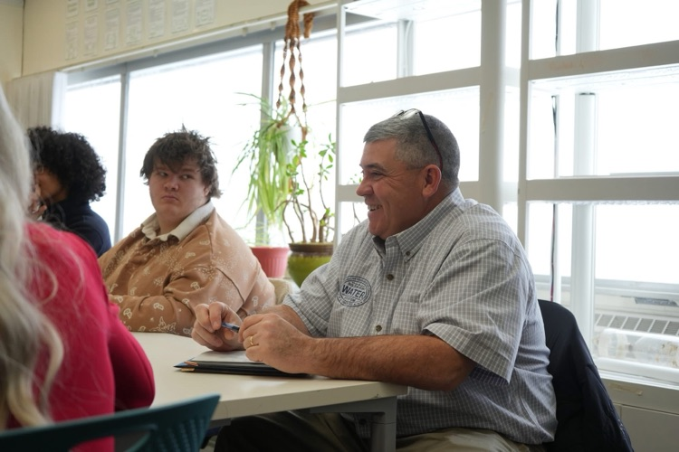 Anna Kelles visits ptech students to discuss HABs. this image shows an audience member asking a question to Dr. Kelles  