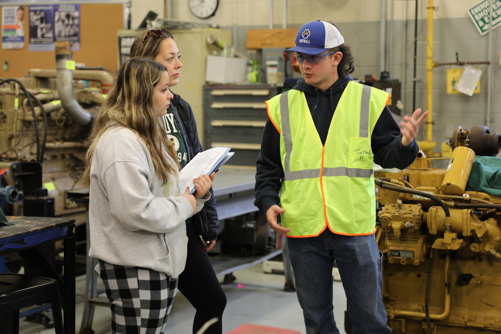 A current student showing potential news students about their program