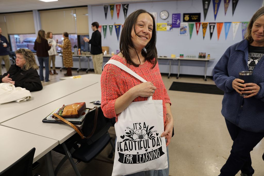 Celebrating Jennifer Hightower, TST's newest National Board Certified Teacher: Jennifer Smiling with bag that says its a beautiful day for learning