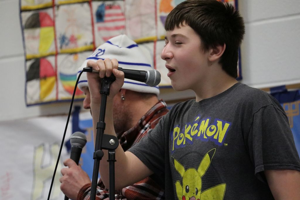 A student and an adult performing at the talent show