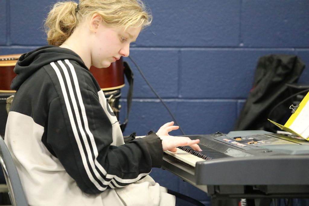 A student playing piano at the talent show