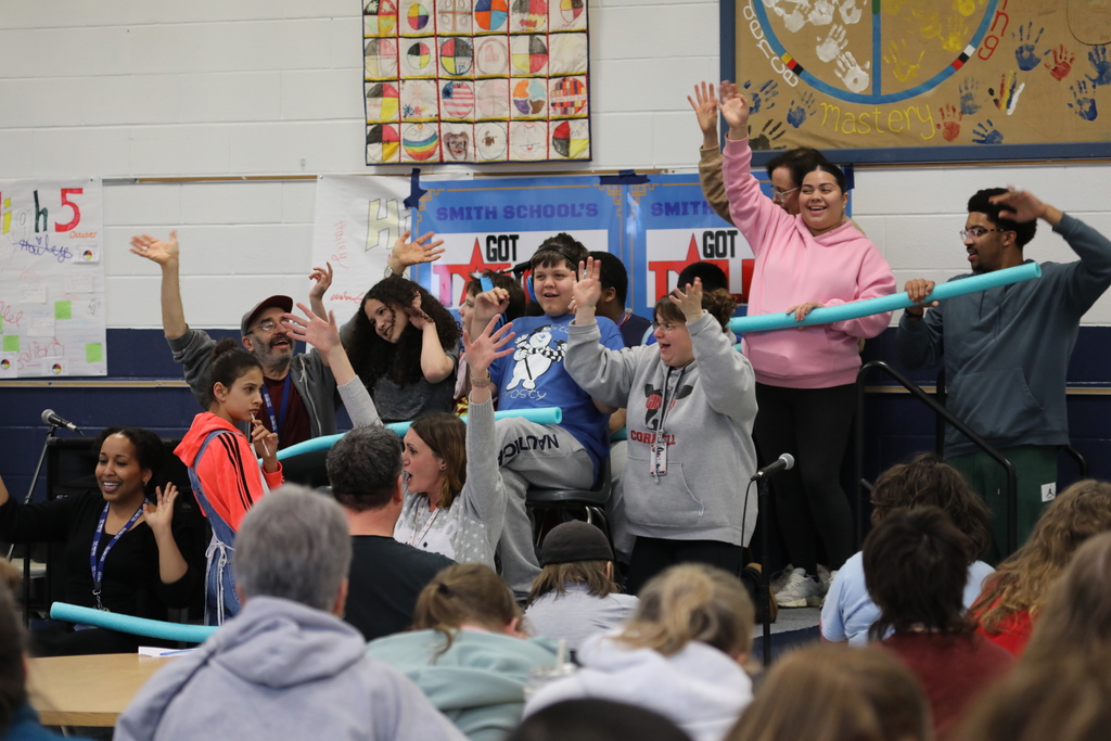 a large group of student performing at the talent show
