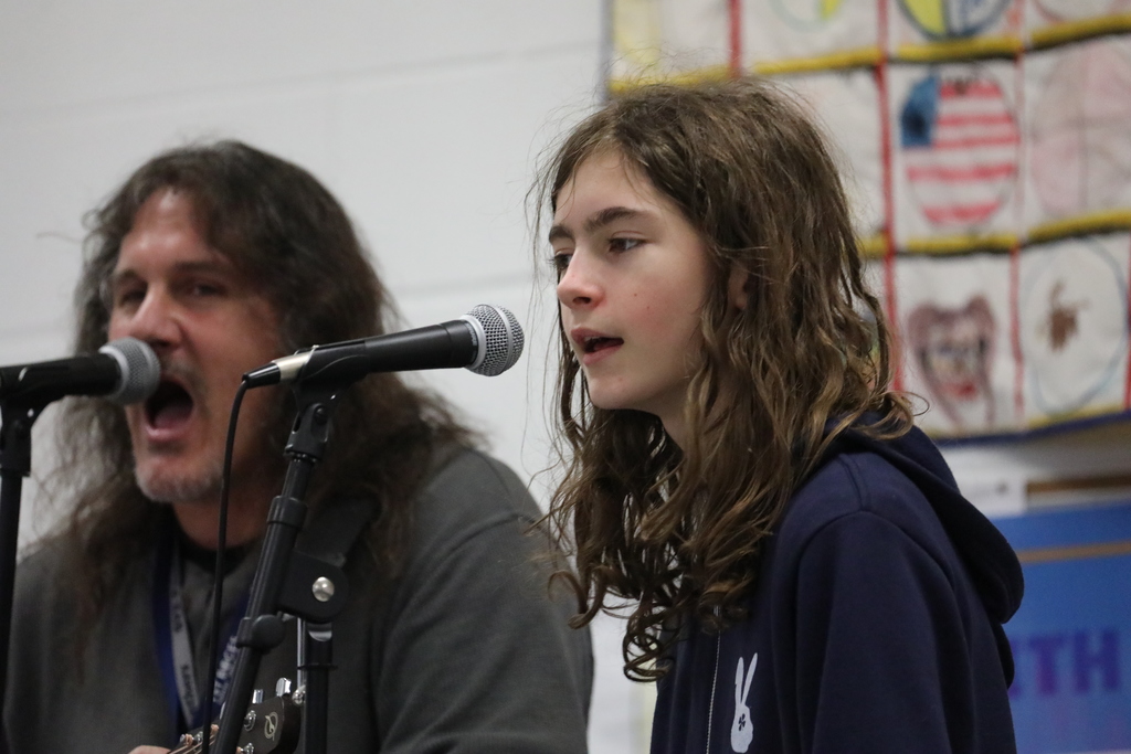 A student and an adult perform at the talent show