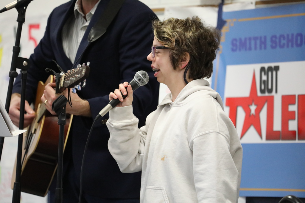 A student and a teacher performing at the talent show