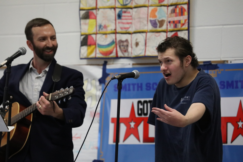 A student and a teacher performing at the talent show