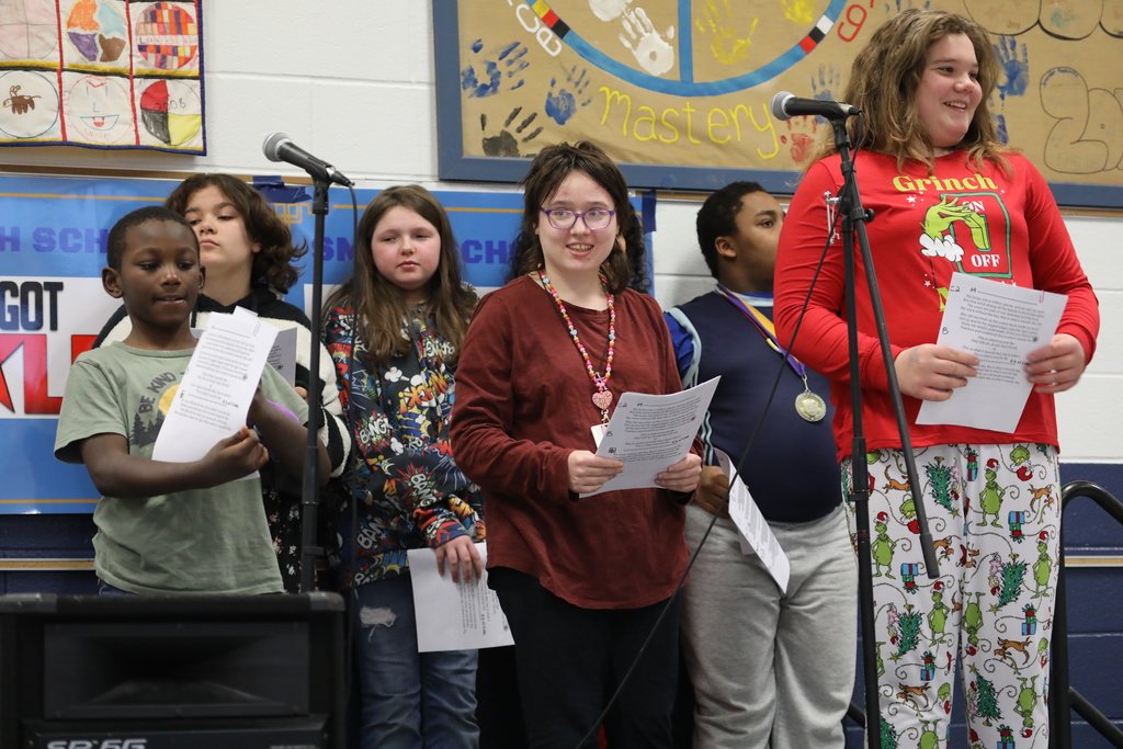 A group of students about to perform a song at the talent show