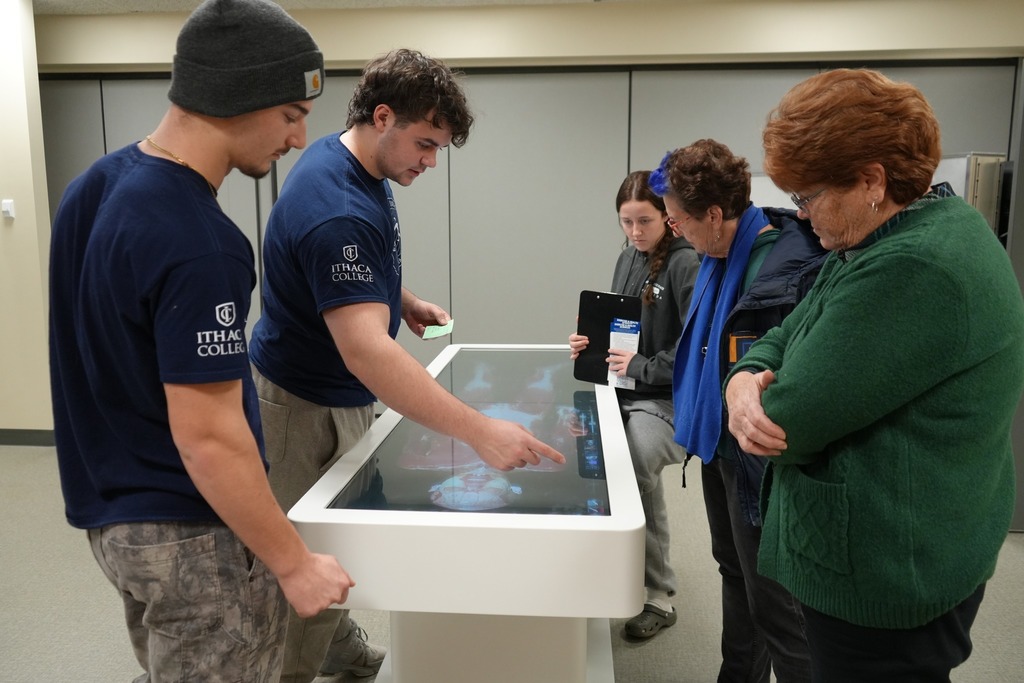 New Visions Exercise and Health Sciences students demonstrate an interactive anatomy table to Board of Education members during a campus tour.