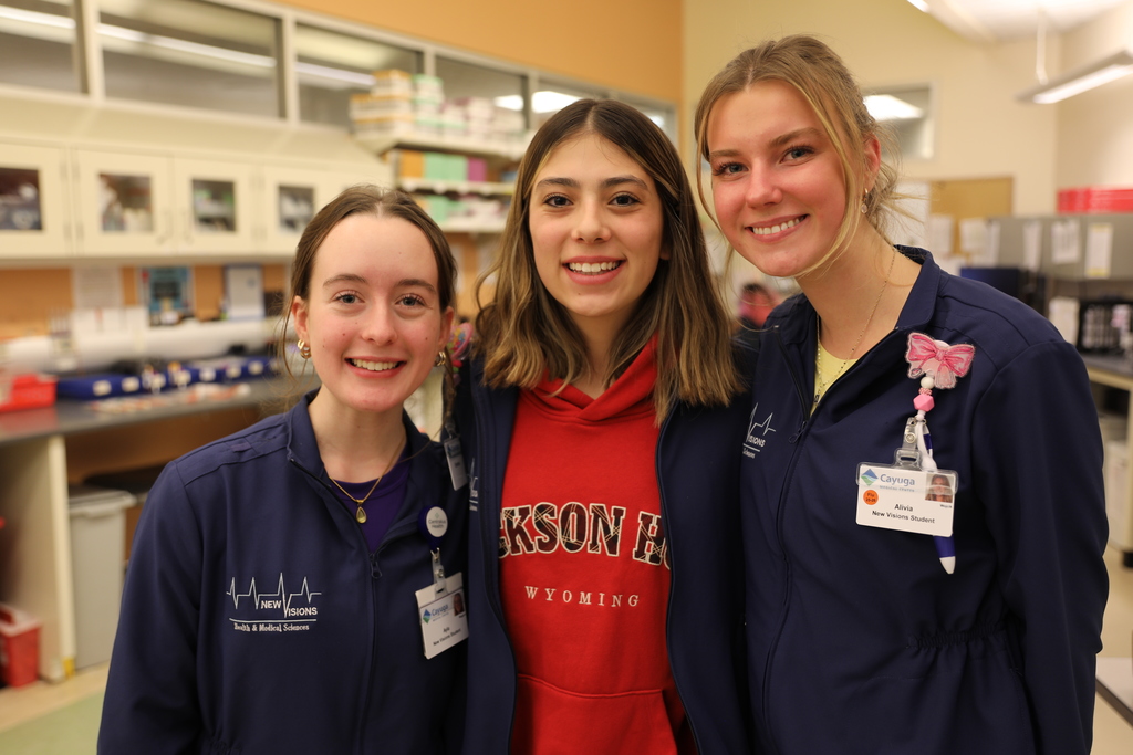 three students smiling for camera