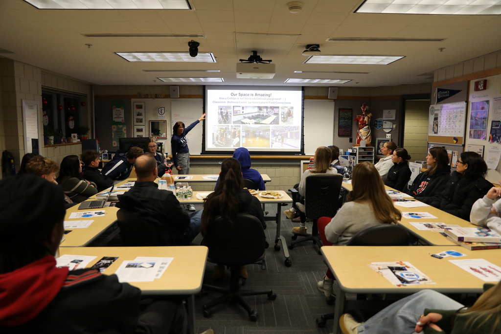 a teacher showing info to a classroom