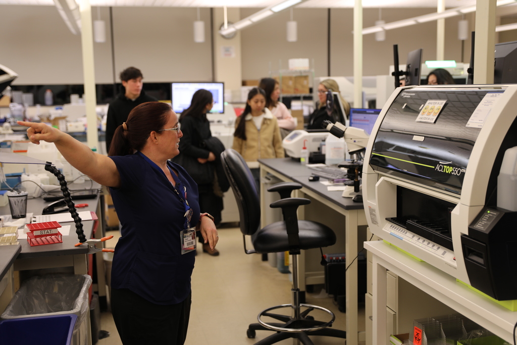 a staff member showing the lab to students