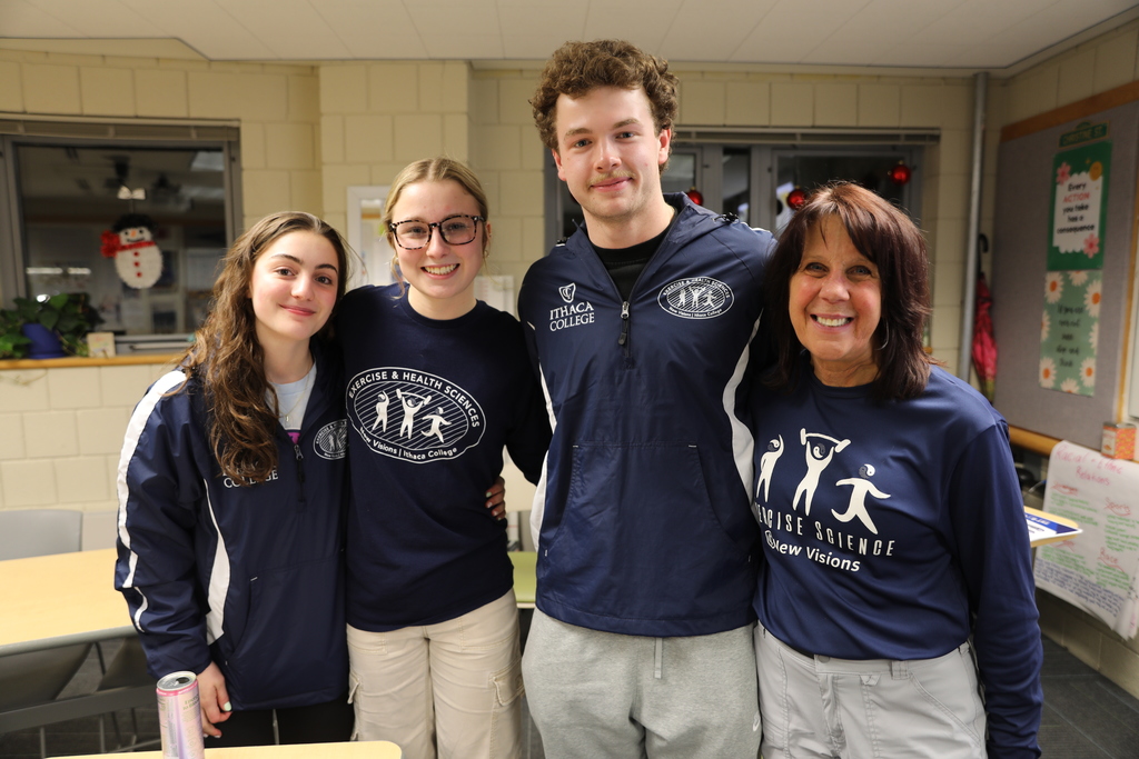 students posing with teacher for a photo