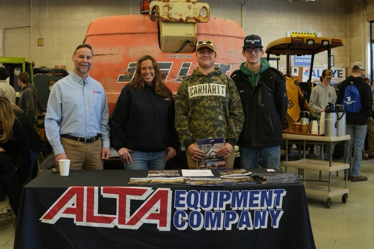 Heavy Equipment students meet with industry partners while equipment and tools are visible in the classroom.