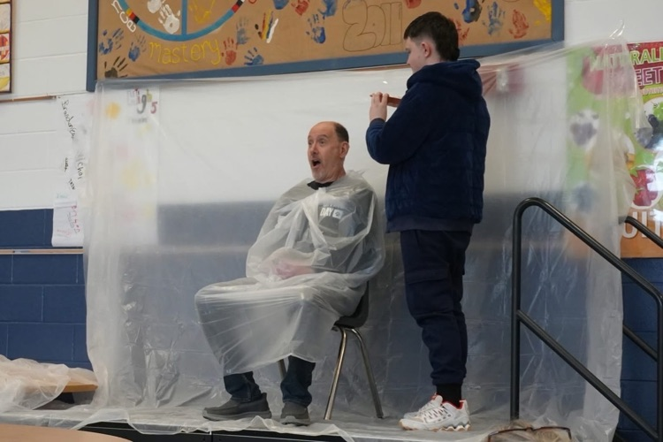 staff member has shocked face just before he gets a pie to the face by a student 