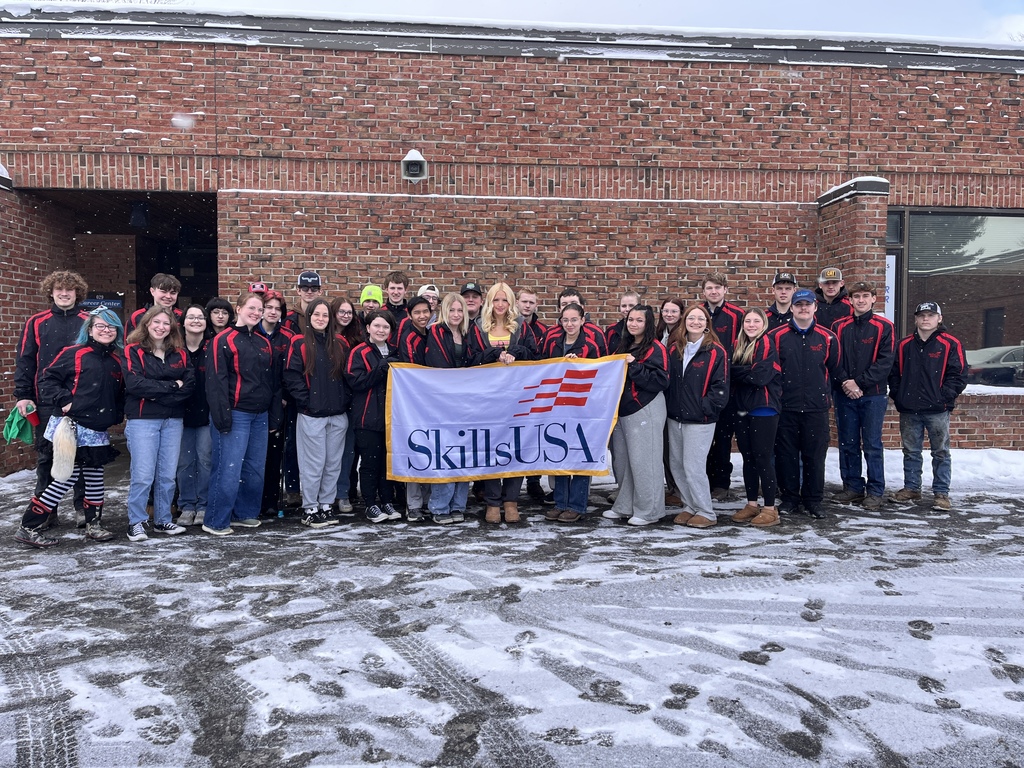 Senior CTE students hold SkillsUSA banner at TST BOCES