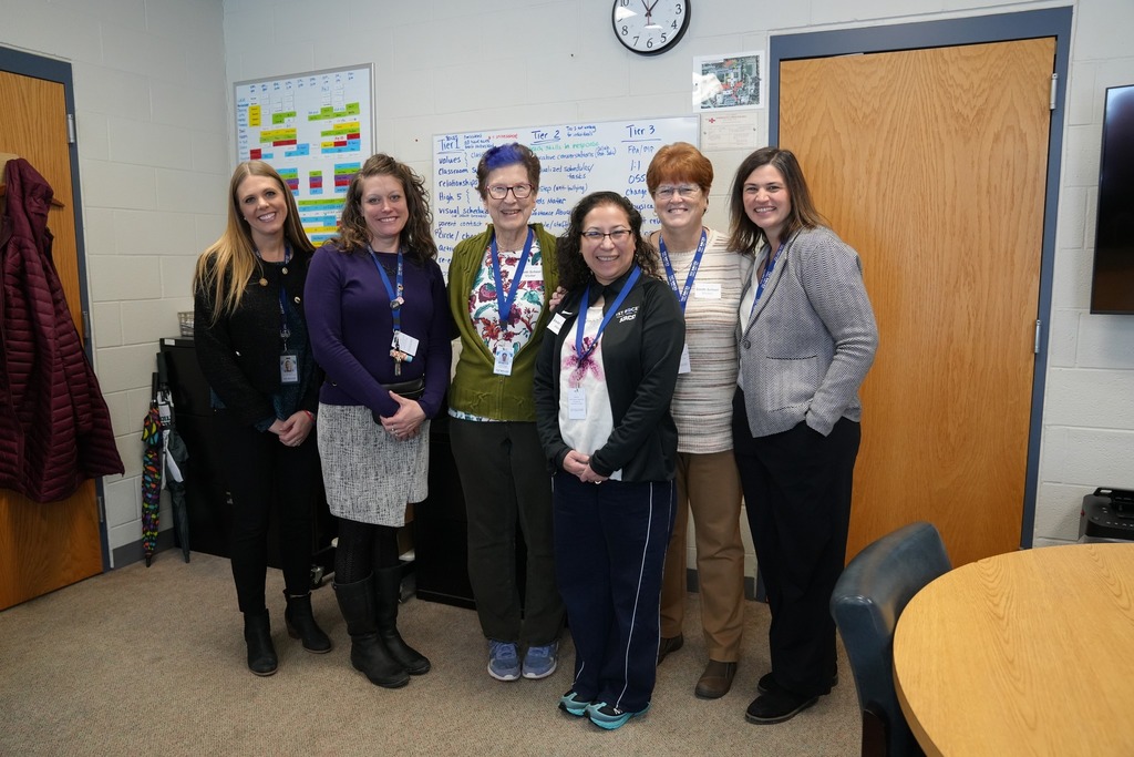TST staff members and Board of Education members pose together in  Smith School during a tour of Exceptional Education programs.